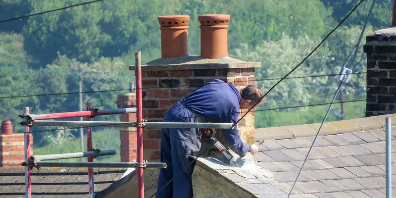 Roofer repairing a chimney